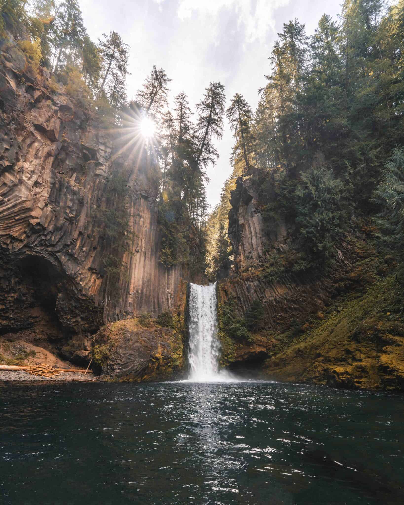 Grace standing on a rock below Toketee Falls during her August 2020 visit