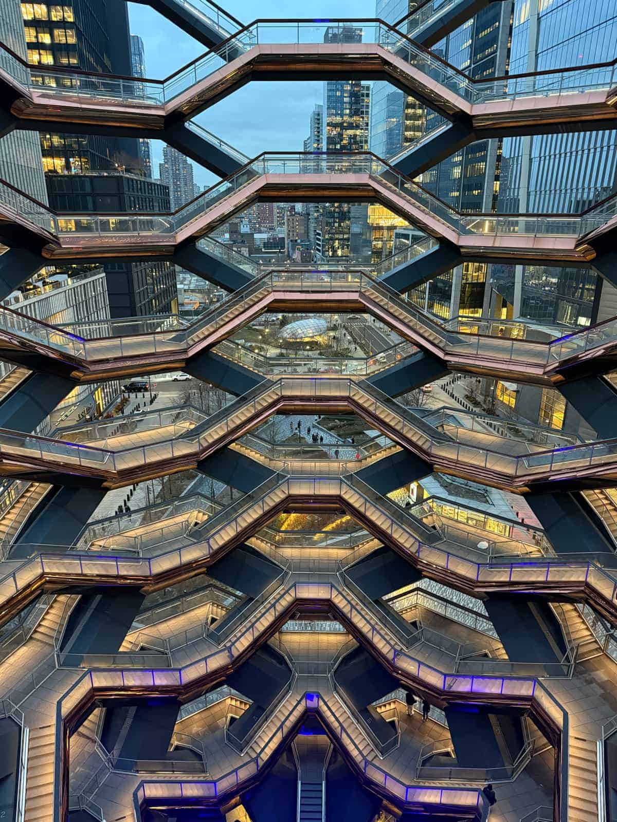 Layered staircases inside the Vessel with Midtown buildings beyond