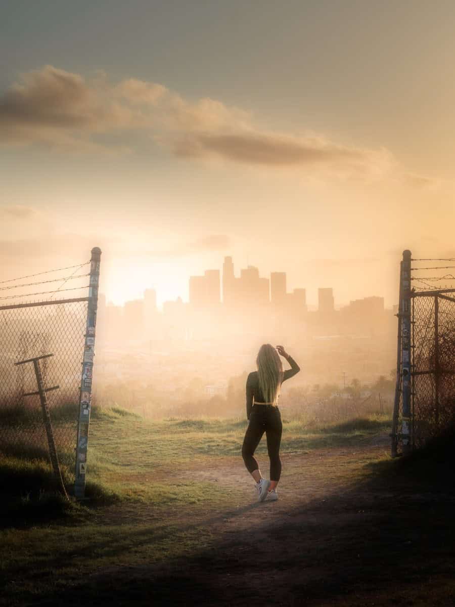 A person on an Ascot Hills path with golden light over the skyline