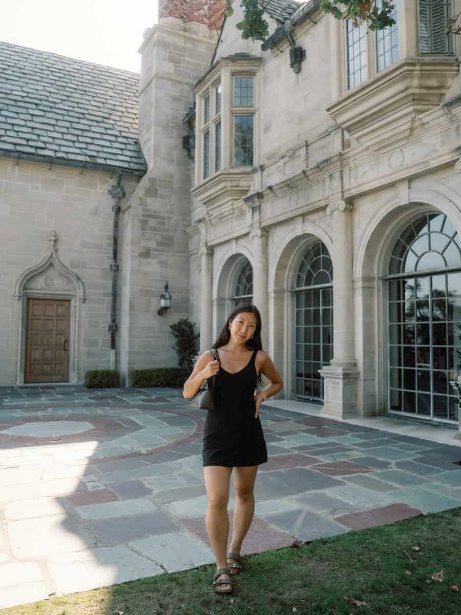 Grace beside the stone exterior of Greystone Mansion