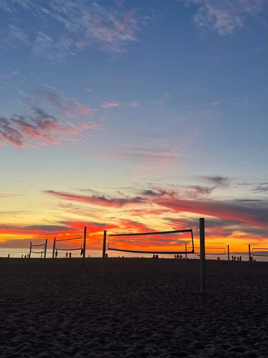Volleyball nets silhouetted against a Hermosa Beach sunset