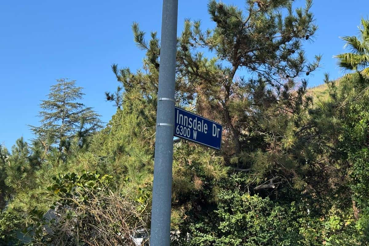 Innsdale Trail street sign beside trees near the Hollywood Sign hike