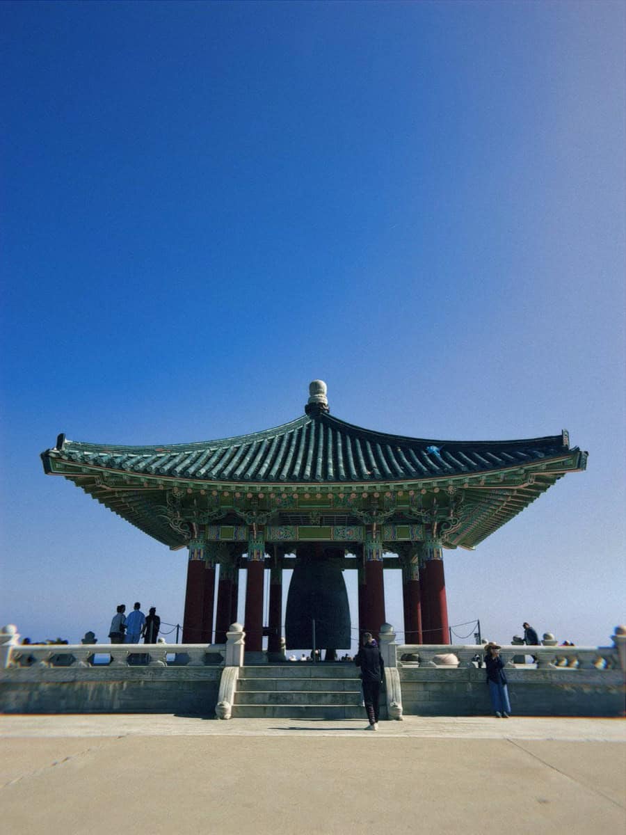 Korean Friendship Bell pavilion under a clear blue sky