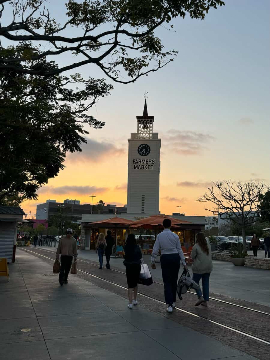 Original Farmers Market clock tower beneath an evening sky