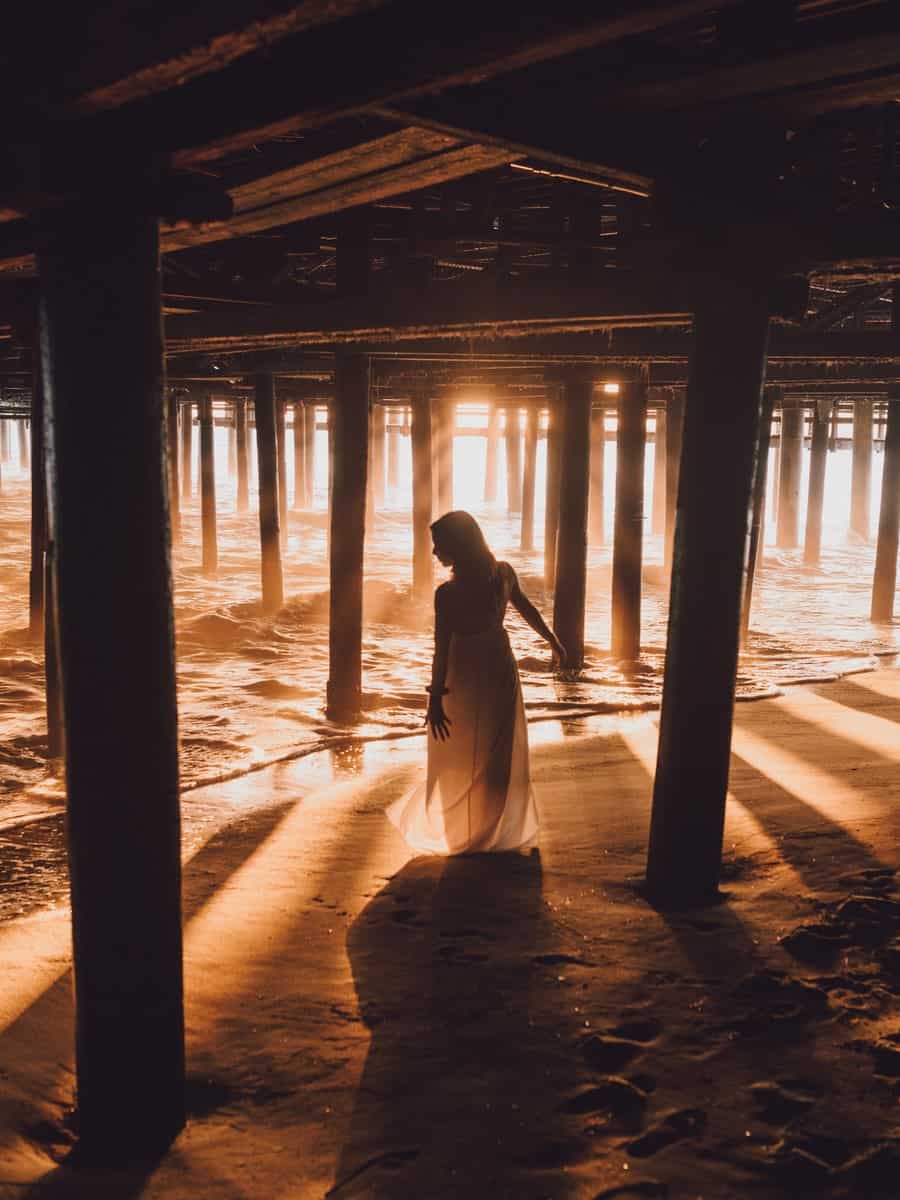 Sunset light between the supports beneath Santa Monica Pier