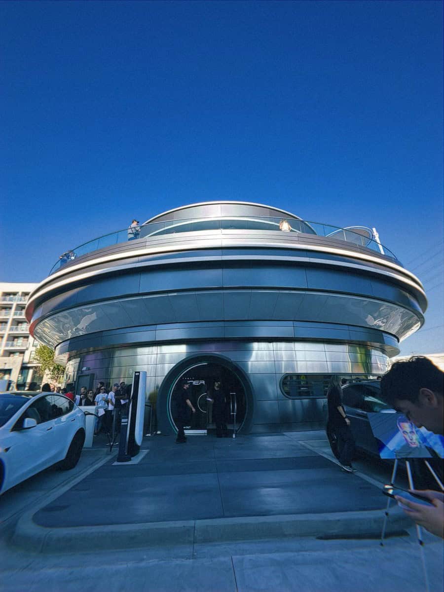 Rounded metal exterior of Tesla Diner beneath a blue sky