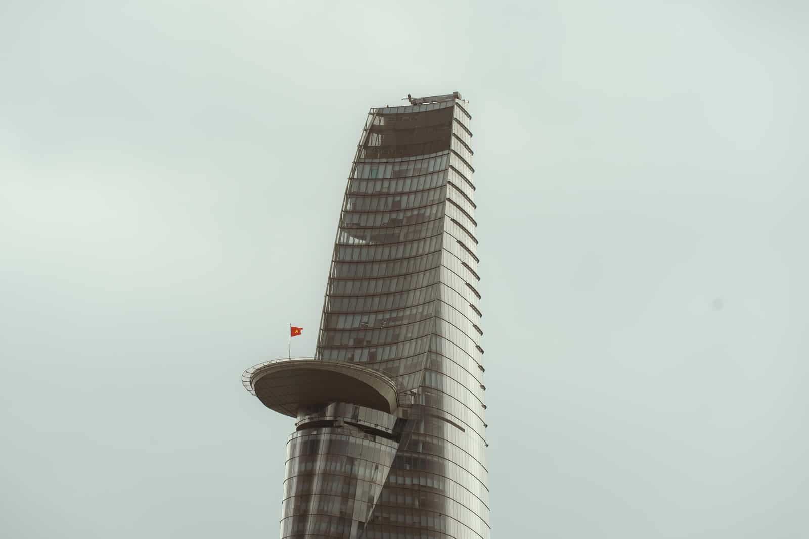 Bitexco Financial Tower and its projecting helipad against a cloudy sky in Ho Chi Minh City