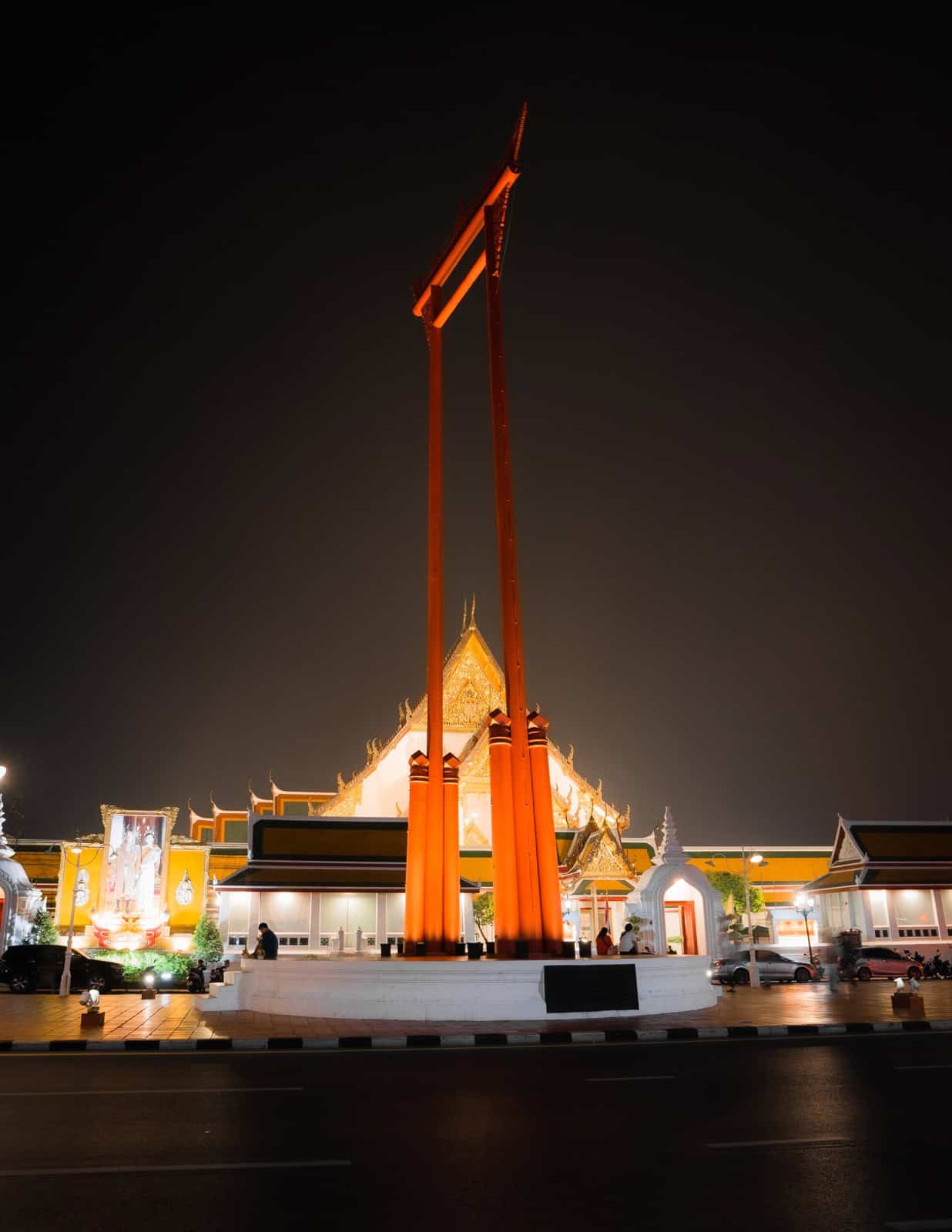 The Giant Swing lit up at night in old Bangkok