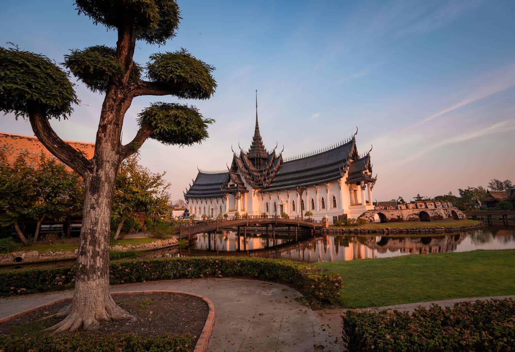 Temple and its reflection in warm evening light at Ancient City, Thailand